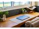 Close-up of a wooden desk with a laptop, plant, and decorative items near a window in a mud room at 6012 N 200 W, Greenfield, IN 46140