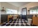 Well-lit mud room with checkered floors, a wooden desk, and plenty of natural light from large windows at 6012 N 200 W, Greenfield, IN 46140