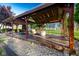 Covered outdoor patio with timbered enclosure, patio furniture and seating area, perfect for relaxation at 6012 N 200 W, Greenfield, IN 46140