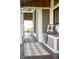 Cozy covered porch area with a rug, built-in bench, and comfortable throw pillow creating an inviting spot at 6012 N 200 W, Greenfield, IN 46140
