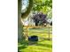 A tree with a tire swing, a fenced yard, a gazebo and a barn in the background on a sunny day at 6012 N 200 W, Greenfield, IN 46140