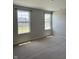 Light-filled bedroom featuring soft carpeting and large windows with neighborhood views at 614 Corbin Way, Avon, IN 46123