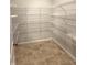 Spacious pantry features tiled flooring and white, adjustable shelving for optimal storage at 614 Corbin Way, Avon, IN 46123