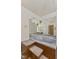 Unique bathroom featuring a blue soaking tub with carpeted steps and a large mirror at 618 Mellowood Dr, Indianapolis, IN 46217