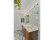 A spacious bathroom with dual sinks, ample lighting, and closet space at 618 Mellowood Dr, Indianapolis, IN 46217