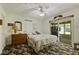Comfortable bedroom with a ceiling fan, dresser, and sliding door to the outside at 618 Mellowood Dr, Indianapolis, IN 46217