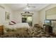 Bright bedroom with a ceiling fan, sliding door, and TV at 618 Mellowood Dr, Indianapolis, IN 46217