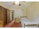 This bedroom features patterned wallpaper, ceiling fan, and ample closet space at 618 Mellowood Dr, Indianapolis, IN 46217