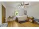 Bright bedroom featuring hardwood floors, ceiling fan and an abundance of natural light at 618 Mellowood Dr, Indianapolis, IN 46217