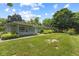 Charming single story home with stone exterior, screened porch, and a lush green yard at 618 Mellowood Dr, Indianapolis, IN 46217