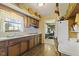 Charming kitchen with wood cabinets, a window over the sink, and appliances at 618 Mellowood Dr, Indianapolis, IN 46217