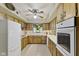 Kitchen with white appliances, plenty of cabinets, and a ceiling fan at 618 Mellowood Dr, Indianapolis, IN 46217