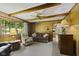 Inviting living area with wood paneling, carpet, and natural light at 618 Mellowood Dr, Indianapolis, IN 46217