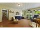 Spacious living room with a comfortable blue sofa and access to the outdoors through french doors at 618 Mellowood Dr, Indianapolis, IN 46217