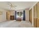 Traditional living room with neutral carpet, classic furniture, and a ceiling fan at 618 Mellowood Dr, Indianapolis, IN 46217