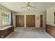 This living room features neutral carpet, classic furniture, a ceiling fan, and a window with natural light at 618 Mellowood Dr, Indianapolis, IN 46217
