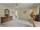 Carpeted main bedroom featuring a large dresser and an ensuite at 618 Mellowood Dr, Indianapolis, IN 46217