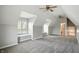 Bright attic bedroom with dormer windows, ceiling fans, and plush carpeting at 6183 Whitetail Run, Greenwood, IN 46143