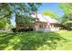 Well-manicured backyard featuring a deck, brick exterior, and lush lawn at 6183 Whitetail Run, Greenwood, IN 46143