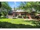Beautiful backyard with a wooden deck, manicured lawn, and lush greenery at 6183 Whitetail Run, Greenwood, IN 46143