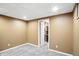 A basement room with carpet and a door to a closet with shelving, ready for your personal touch at 6183 Whitetail Run, Greenwood, IN 46143