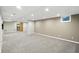 Finished basement area with carpet, recessed lighting, and an unfinished storage room with shelving at 6183 Whitetail Run, Greenwood, IN 46143