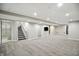 Large finished basement with stairs, bathroom, and tv viewing area, perfect for entertaining or relaxing at 6183 Whitetail Run, Greenwood, IN 46143