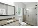 Bathroom vanity with granite counters, a framed mirror, and a glass shower with tile surround at 6183 Whitetail Run, Greenwood, IN 46143