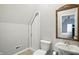Cozy bathroom featuring a wood-framed mirror, toilet, and tiled floors at 6183 Whitetail Run, Greenwood, IN 46143