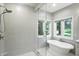 Modern bathroom featuring a soaking tub, tiled stand-up shower, and white vanity at 6183 Whitetail Run, Greenwood, IN 46143