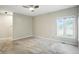 Bedroom with a window letting in sunlight and plush gray carpet at 6183 Whitetail Run, Greenwood, IN 46143