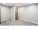 Cozy bedroom with neutral carpeting, a warm wood door, and ample natural light at 6183 Whitetail Run, Greenwood, IN 46143