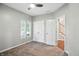 A bedroom featuring neutral walls, a ceiling fan, double closets, and a window with natural light at 6183 Whitetail Run, Greenwood, IN 46143
