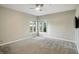 Carpeted bedroom with two windows to let in natural light, plus a mounted TV at 6183 Whitetail Run, Greenwood, IN 46143