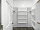 Organized walk-in closet with multiple shelves and hanging racks for storage at 6183 Whitetail Run, Greenwood, IN 46143