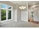 Bright dining room with neutral paint, carpet floors, and modern lighting fixtures for hosting guests at 6183 Whitetail Run, Greenwood, IN 46143