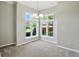 Bright dining room featuring large windows, neutral paint, and modern lighting fixtures for hosting guests at 6183 Whitetail Run, Greenwood, IN 46143