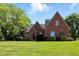 Charming brick home featuring well-maintained lawn and mature trees, offering a serene outdoor setting at 6183 Whitetail Run, Greenwood, IN 46143