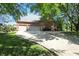 Charming brick home with three-car garage, long driveway, and mature trees at 6183 Whitetail Run, Greenwood, IN 46143