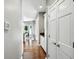Hallway features hardwood floors, white trim, and access to the kitchen and other rooms at 6183 Whitetail Run, Greenwood, IN 46143