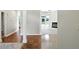 Bright hallway with hardwood floors leading to the living room with fireplace and backyard views at 6183 Whitetail Run, Greenwood, IN 46143