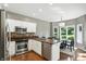 Eat-in kitchen boasts stainless steel appliances, breakfast nook, and granite countertops at 6183 Whitetail Run, Greenwood, IN 46143