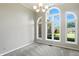 Bright living room with neutral walls, carpet floors, and arched windows offering stunning views of the outdoors at 6183 Whitetail Run, Greenwood, IN 46143