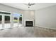 Bright living room with a fireplace and sliding glass doors to a deck with greenery at 6183 Whitetail Run, Greenwood, IN 46143