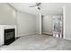 Large living room with gray carpet and fireplace with access to bright windows and a hallway at 6183 Whitetail Run, Greenwood, IN 46143