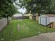 Spacious backyard with mature trees, shed, and a fenced yard at 624 Warren Ave, Indianapolis, IN 46221