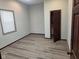 Bright bedroom with gray walls, hardwood flooring, window, and walk-in closet at 624 Warren Ave, Indianapolis, IN 46221