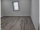 Bright bedroom with gray walls and hardwood flooring plus a view of the window at 624 Warren Ave, Indianapolis, IN 46221