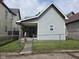 Charming bungalow featuring a gray exterior, covered porch and chain link fence at 624 Warren Ave, Indianapolis, IN 46221