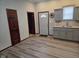 Eat-in kitchen featuring hardwood floors and gray cabinets at 624 Warren Ave, Indianapolis, IN 46221